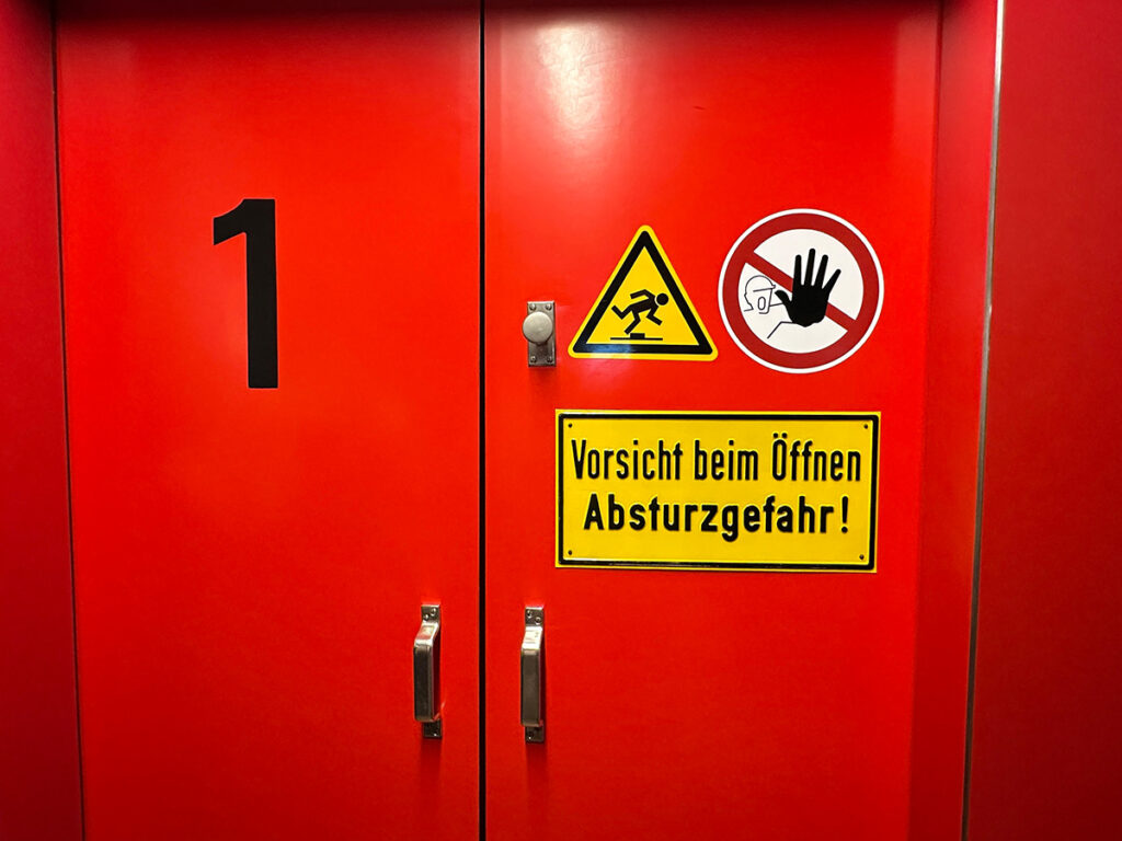 Wenn es los geht, geht es hier los! Dann öffnen sich diese Türen kurz, hinter denen sich die berühmten Rutschstangen befinden, die direkt in die Fahrzeughalle führen. Siehe nächstes Bild...